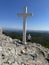 Big cross against the background of the sea. A man near the Christian monument Cross of Jesus. Croatia, Ugljan island, near the