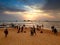 Big crowd looking on the sunset at ocean beach on tropical island