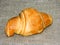 Big delicious French croissant lies on a burlap towel