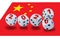Big dice with 2020 2021 written on the sides tumbling with the China flag in the backgrund.