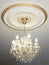 Big electric chandelier on ceiling