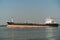 Big, empty shipping boat going up Chao Praya River in Pak Nam, Thailand