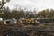 Big excavator during earthmoving works outdoors at construction site. Yellow excavator clears the river bed for the device pond. A