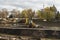 Big excavator during earthmoving works outdoors at construction site. Yellow excavator clears the river bed for the device pond. A