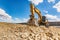 Big excavator moving earth in the construction works of a road