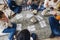 Big family with children sitting on floor near Xmas tree playing lotto board game together