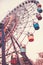 Big Ferris wheel. Bottom view. Toned vertical image in retro style.