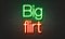 Big flirt neon sign on brick wall background.