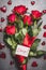 Big flowers bunch with red roses , ribbon , i love you lettering card and hearts on gray background