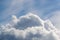 A big and fluffy cumulonimbus cloud in the blue sky background