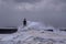 Big foamy waves of the stormy sea splashing on the Farolim de Felgueiras lighthouse in Portugal