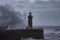 Big foamy waves of the stormy sea splashing on the Farolim de Felgueiras lighthouse in Portugal