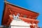 Big fox stone statue on the stage inside Fushimi Inari Shrine area in Japan.  Japanese Language on top of construction mean `Fush