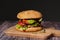 Big fried cheeseburger on a dark background