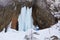 Big frozen waterfall in Seven Ladders Canyon Canionul Sapte Scari, a popular hiking destination in Winter in Brasov, Romania