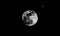 Big full moon against clear dark starry sky background in black and white. Moon, starry sky, cosmos, planets.