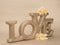 Big gold letters LOVE on silver background