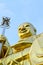 Big golden Bodhisattva statue with blue sky