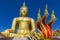 Big golden buddha statue and serpent king statue in buddhist temple