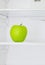 Big green apple in domestic refrigerator taken closeup.Lifestile
