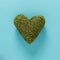 Big green moss heart on blue