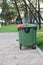 Big green plastic dumpster on the street