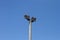 Big grey concrete lighting pole on a blue sky background, objects photo