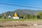 Big grotesque Buddhist monk statue in Thai countryside.