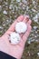 Big hailstones in man hand with hail in floor garden grass background after thunderstorm