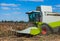 Big harvester in the field on a sunny day mowing ripe, dry sunflower