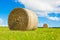 Big hay bale roll in a lush field