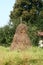 Big haystack. The countryside. Grass and trees.