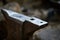 Big heavy anvil in the blacksmith`s workshop, close-up, selective focus.