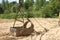 Big heavy bucket lies on sand on summer day