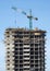 Big hoisting tower crane and construction building