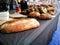 Big Homemade French Baguettes brown bread at Sunday market.