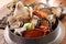 Big hot pot of Tang Emperor of the Sea with fresh octopus, abalone, crab, clams, shrimp and chicken on wooden korean table