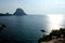 Big and huge pyramidal rock called Es VedrÃ¡ near the island of Ibiza in The Mediterranean Sea