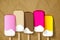 Big ice cream lolly strawberry raspberry pink jelly on a crumpled paper brown background.