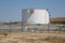 Big Industrial oil tanks in a refinery .Large white industrial tanks for petrochemical or oil or fuel or water in refinery or