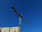 Big iron machinery crane. Deep blue autumn sky