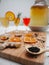 Big jar and glasses with homemade flavored kombucha tea on a white background