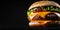 big juicy beef burger on dark background. banner with copy space