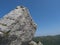 Big limestone boulder at heel of Perda Liana, rock formation on green forest hill, sardinian table mountain. National