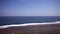 Big long waves and white sea foam hitting the coast of Bali island in Indonesia