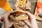 Big lunch. Burger with beef BBQ and fries. Glass of beer on a wooden background. The concept of fast food and unhealthy