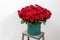 Big luxury bright bouquet on wooden table. One hundred of garden red roses. Color passionately scarlet, Autumn mood