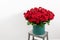 Big luxury bright bouquet on wooden table. One hundred of garden red roses. Color passionately scarlet, Autumn mood