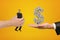 Big male hand passing tiny businessman to another hand with big money dollar sign on yellow background