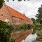 The big manors of Holsteinborg Castle reflecting in the moat